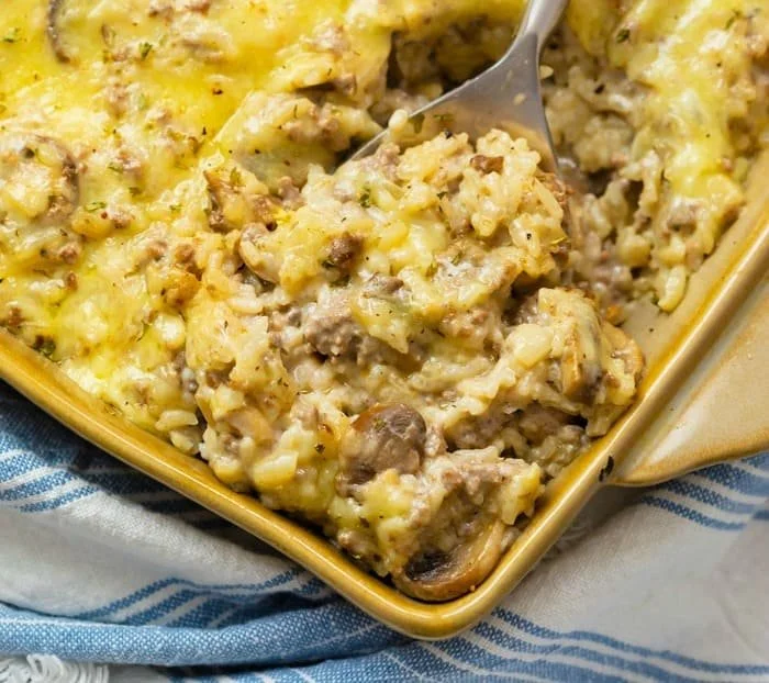 Cheesy ground beef rice casserole served in a baking dish