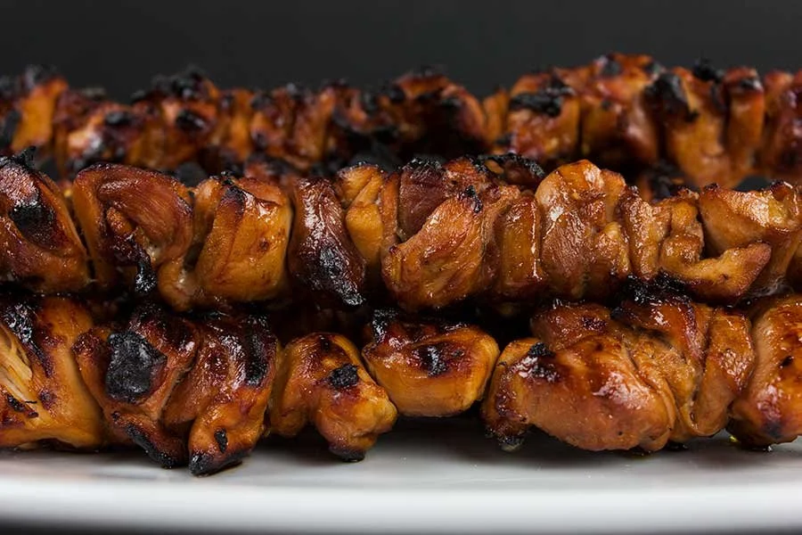 Delicious Filipino grilled chicken kebabs served on skewers with vegetables