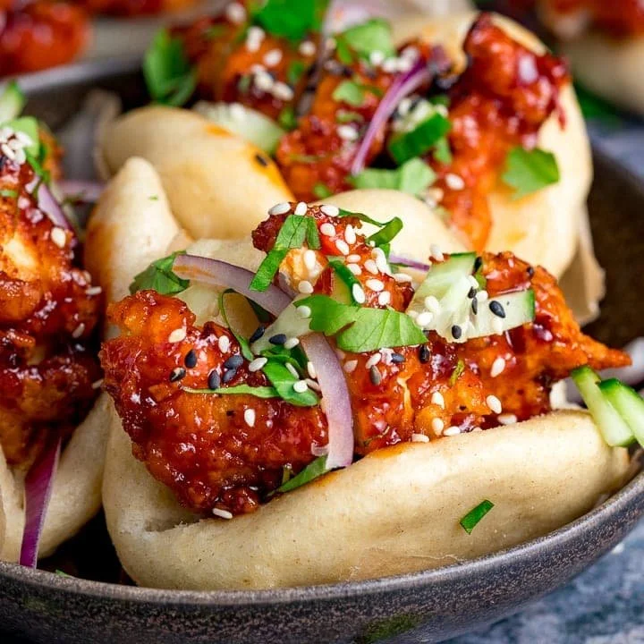 Delicious Korean Chicken Bao with spicy chicken filling in soft bao buns.