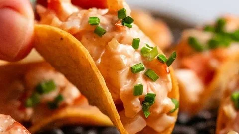Mini tacos filled with prawn cocktail for a flavorful and fun appetizer.