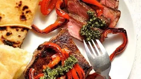 Sirloin steak with pesto and peppers on flatbread, delicious gourmet meal
