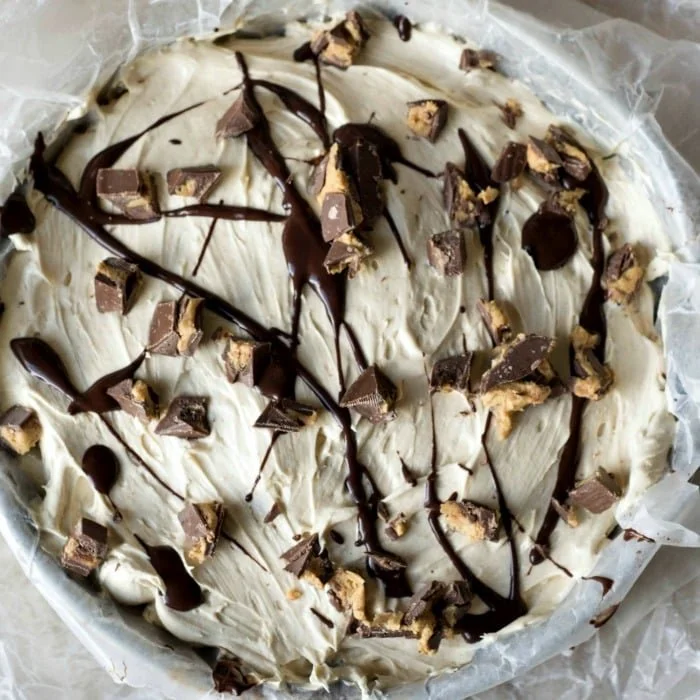 Sugar-Free No-Bake Peanut Butter Pie topped with whipped cream and chocolate drizzle